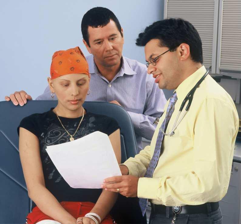 Doctor showing a paper report to a woman with cancer and her parent.